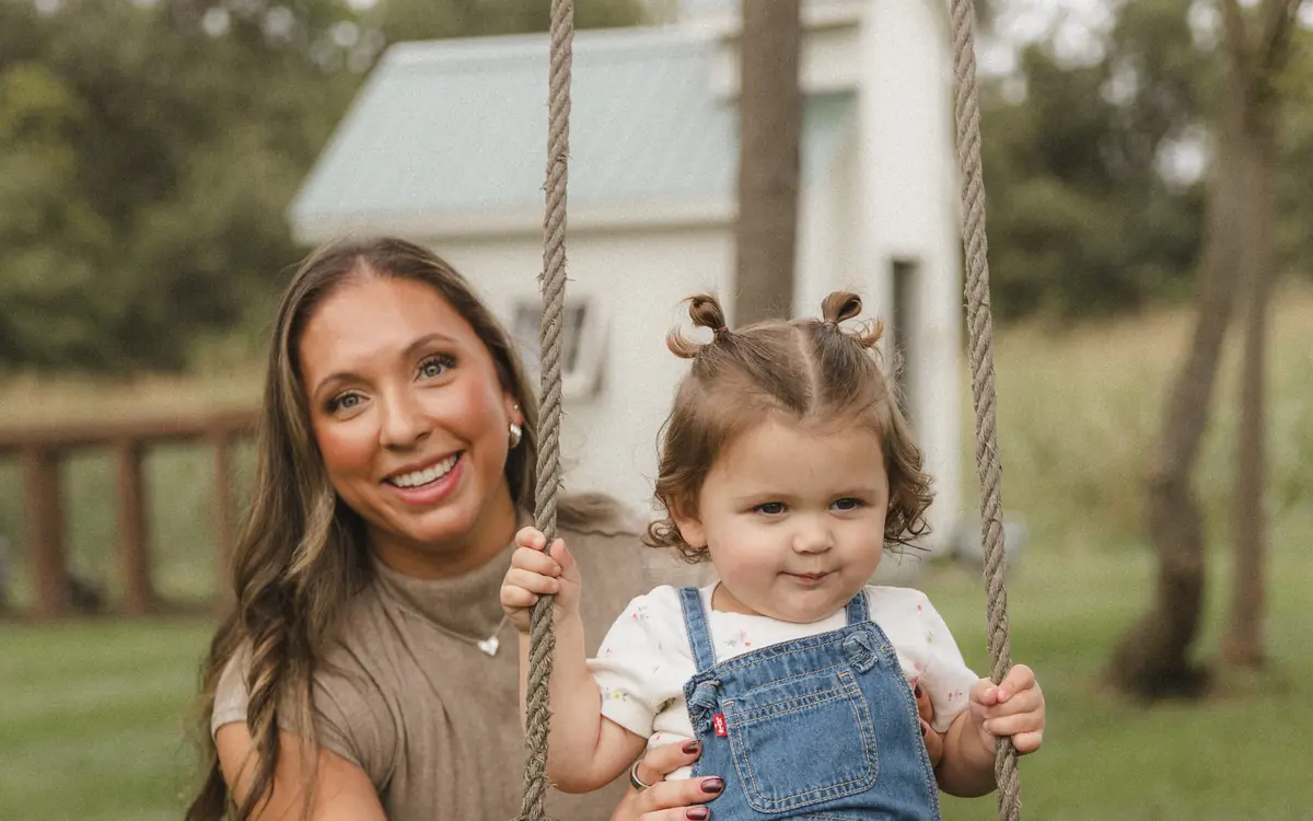 Alli and Summer smiling together at the rope swing